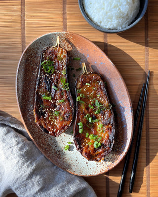 Two piece of miso glazed eggplant and a side of white rice