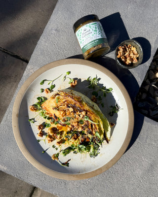 Slice of miso brown butter cabbage next to a jar of Shared Cultures Morel Mushroom Miso