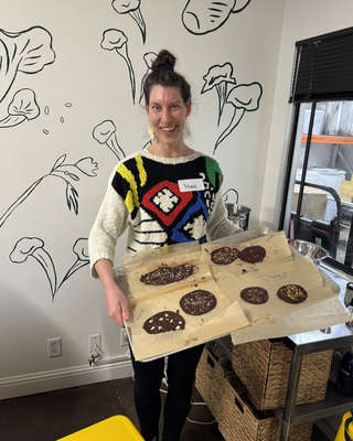 Instructor Marie Brennan holding a tray of miso chocolate bark