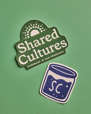 One Shared Cultures green logo sticker and Shared Cultures blue jar logo sticker