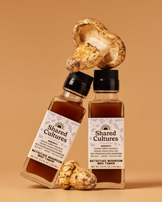 Two bottles of Shared Cultures Matsutake Mushroom Miso Tamari leaning against each other