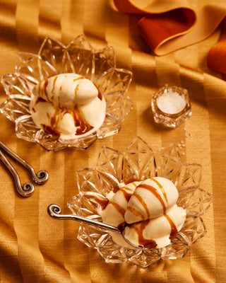 Two bowls with ice cream and caramel sauce 